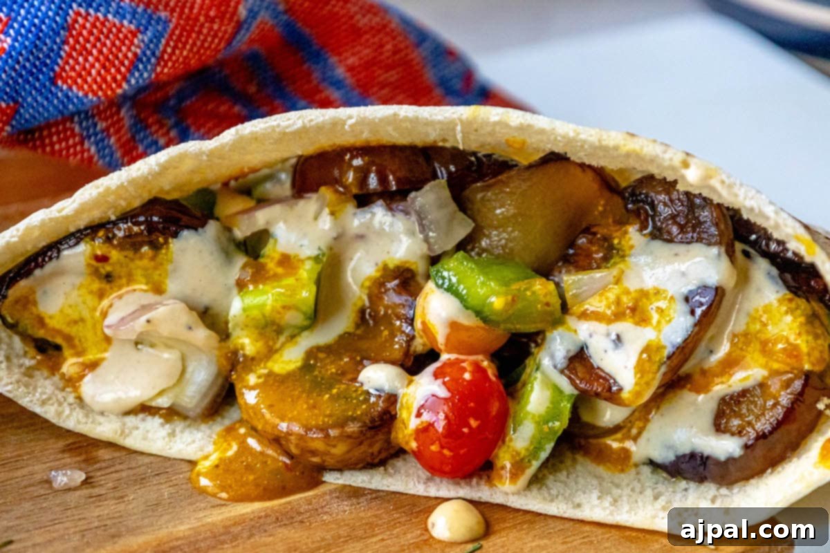 A Vegan Sabich sandwich displayed on a wooden cutting board.