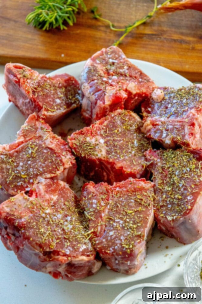 seasoned raw lamb chops on a plate