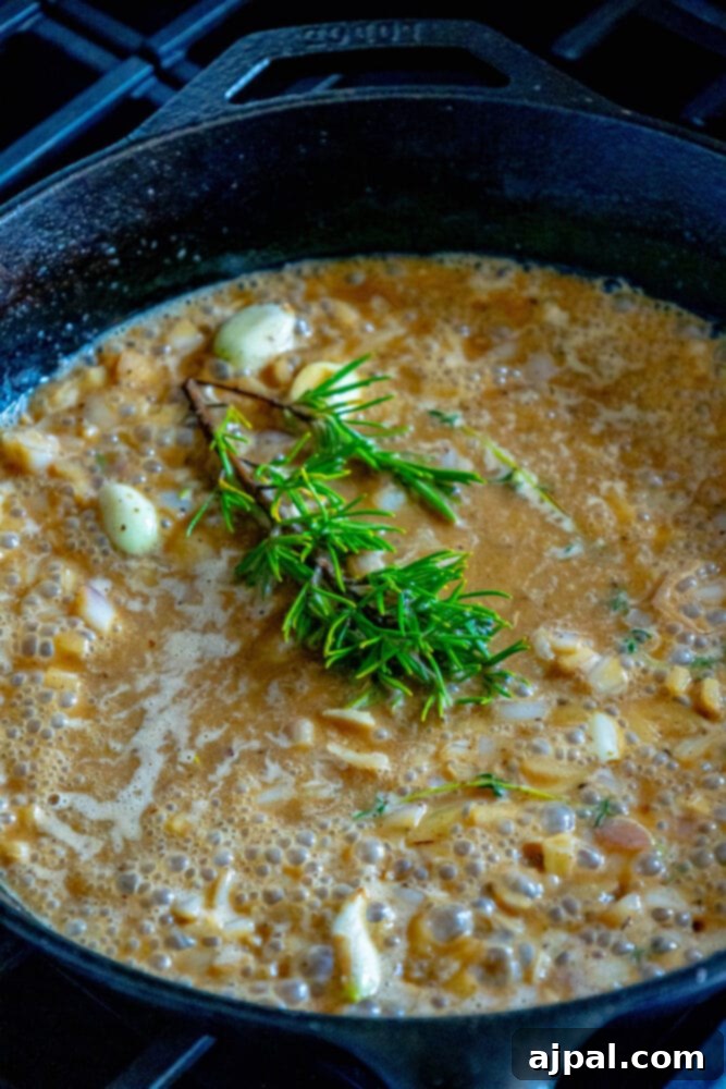 white wine sauce with garlic and rosemary in a cast iron pan