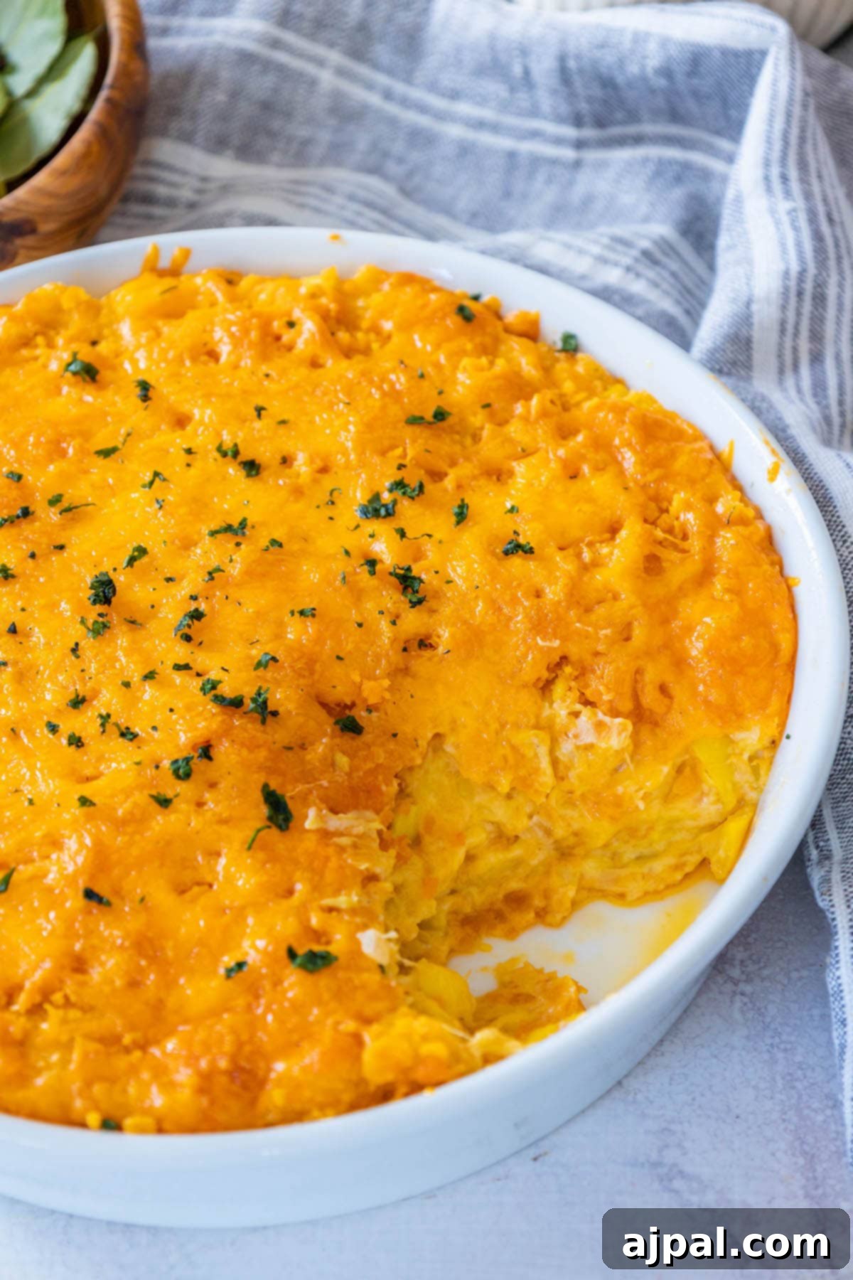 Savory Roasted Squash Gratin 5 A golden-brown cheesy squash casserole, hot and bubbling in a white baking dish, fresh out of the oven, with a crispy cracker topping and vibrant melted cheese visible.