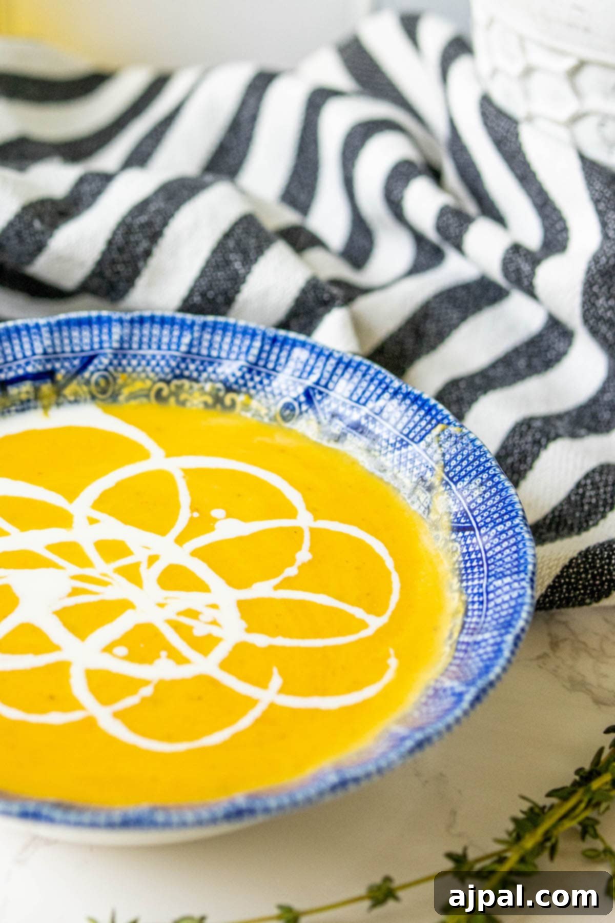 Golden Butternut Perfection 12 yellow soup with white cream decoration