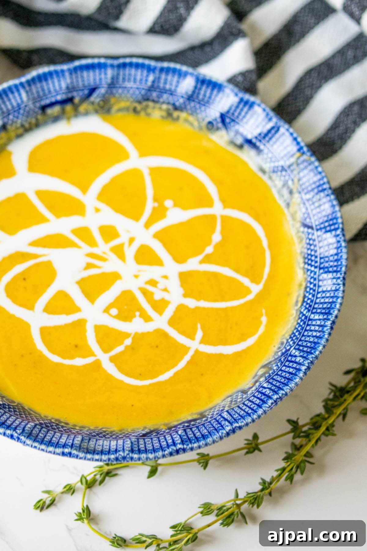 Golden Butternut Perfection 13 yellow soup with white cream decoration