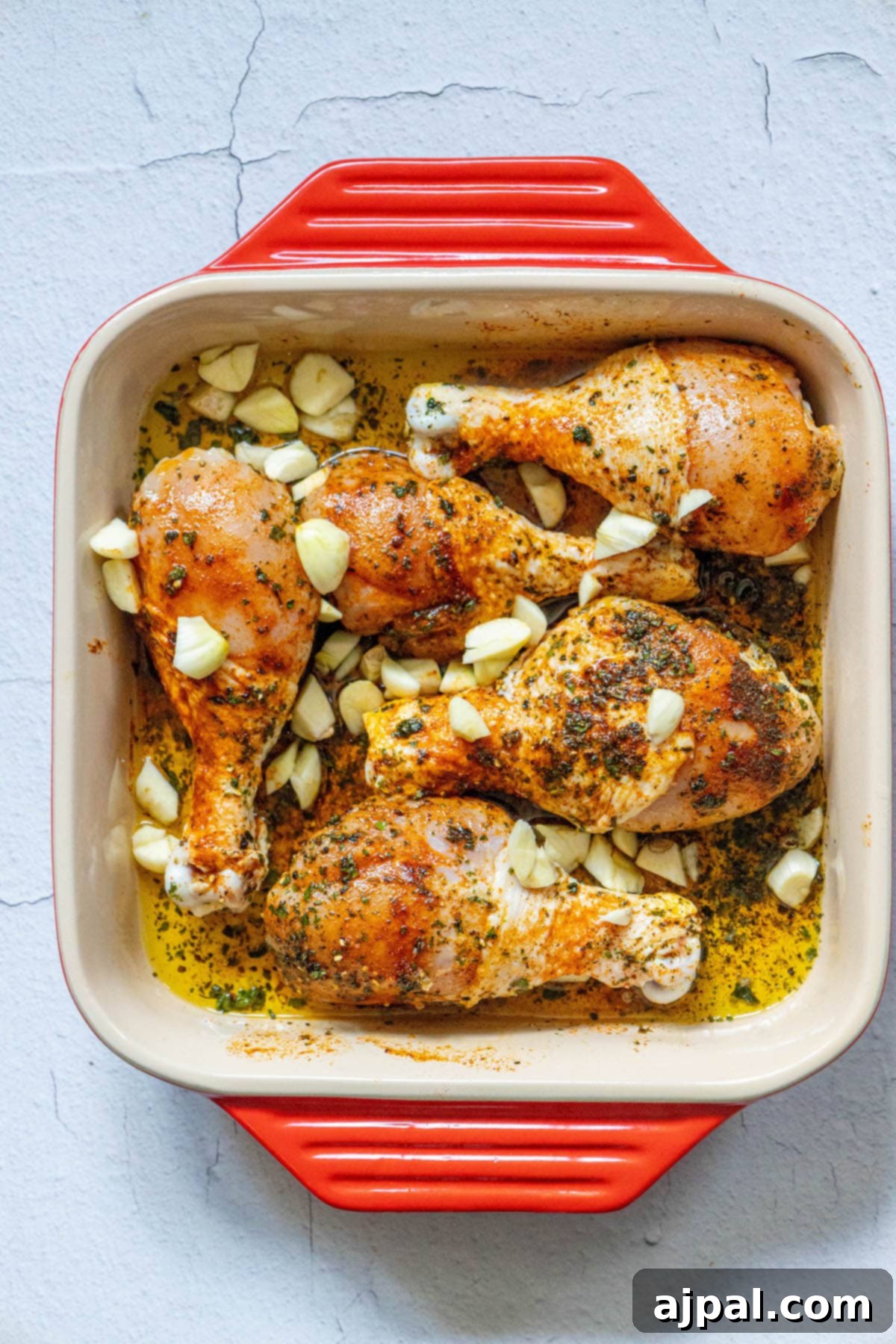 Tender Confit Chicken Legs 4 chicken legs, oil, spices, garlic in a dish