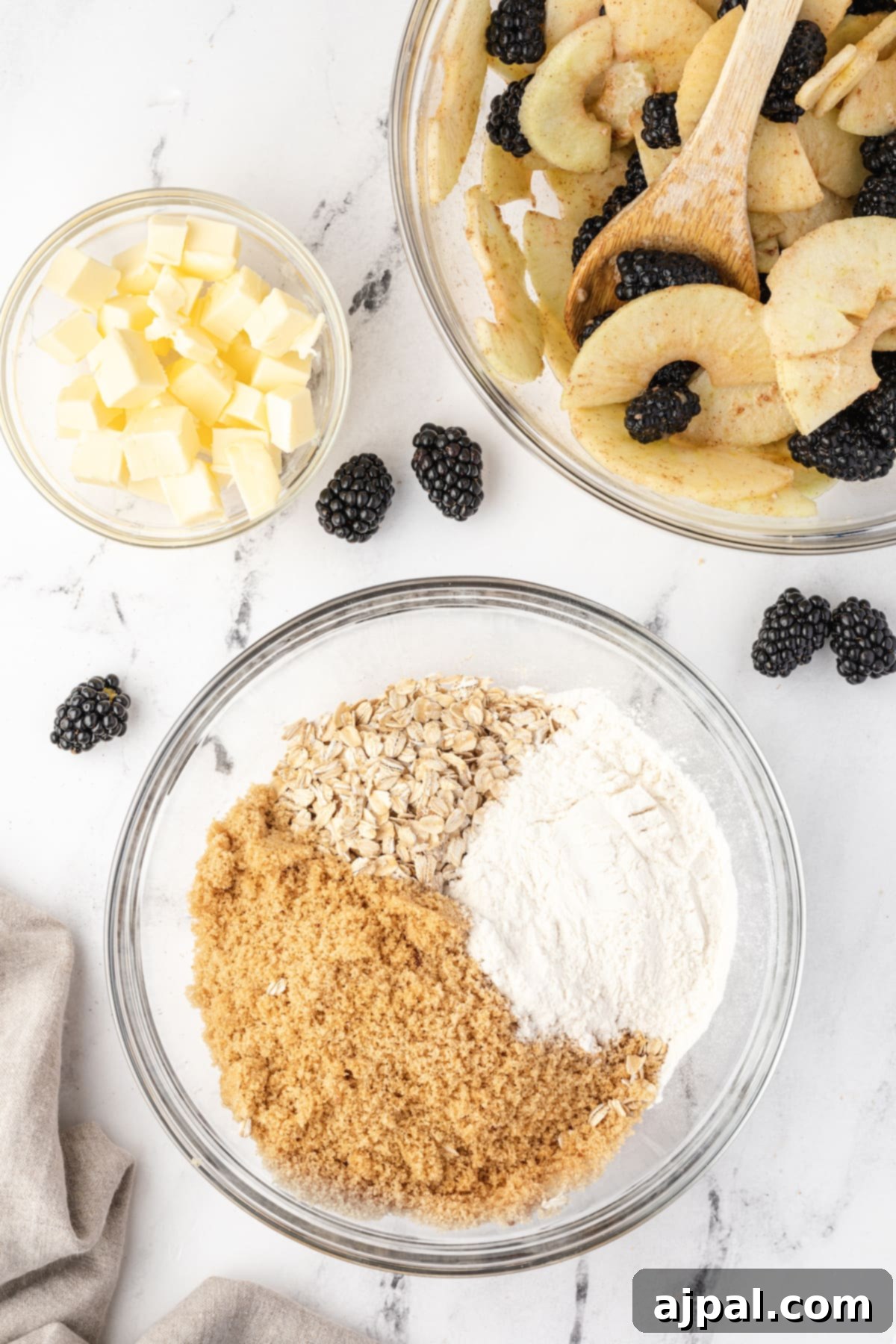Apple and Blackberry Crumble 7 Blackberry crumble ingredients in a bowl, showing the flour, oats, brown sugar, and butter