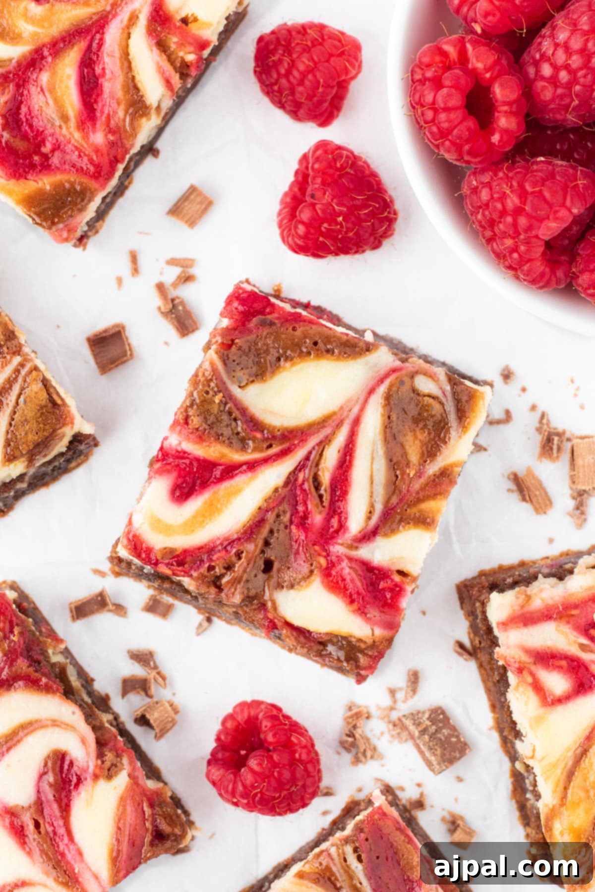 Ultimate Raspberry Cheesecake Brownies 2 cheesecake marbled brownie bar with raspberry sauce on top
