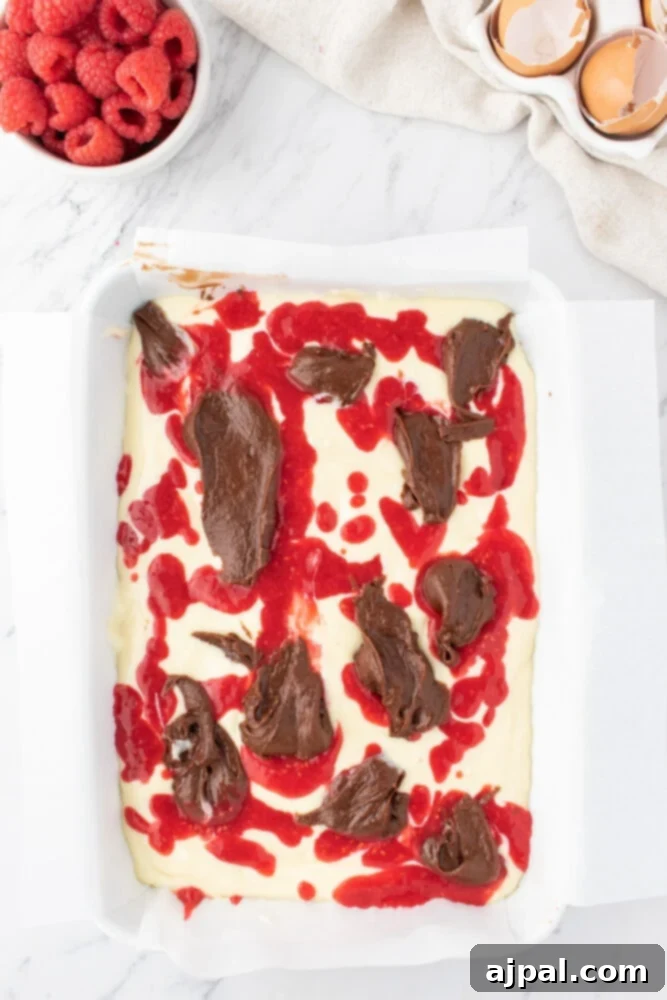 Ultimate Raspberry Cheesecake Brownies 12 brownie batter in a glass dish