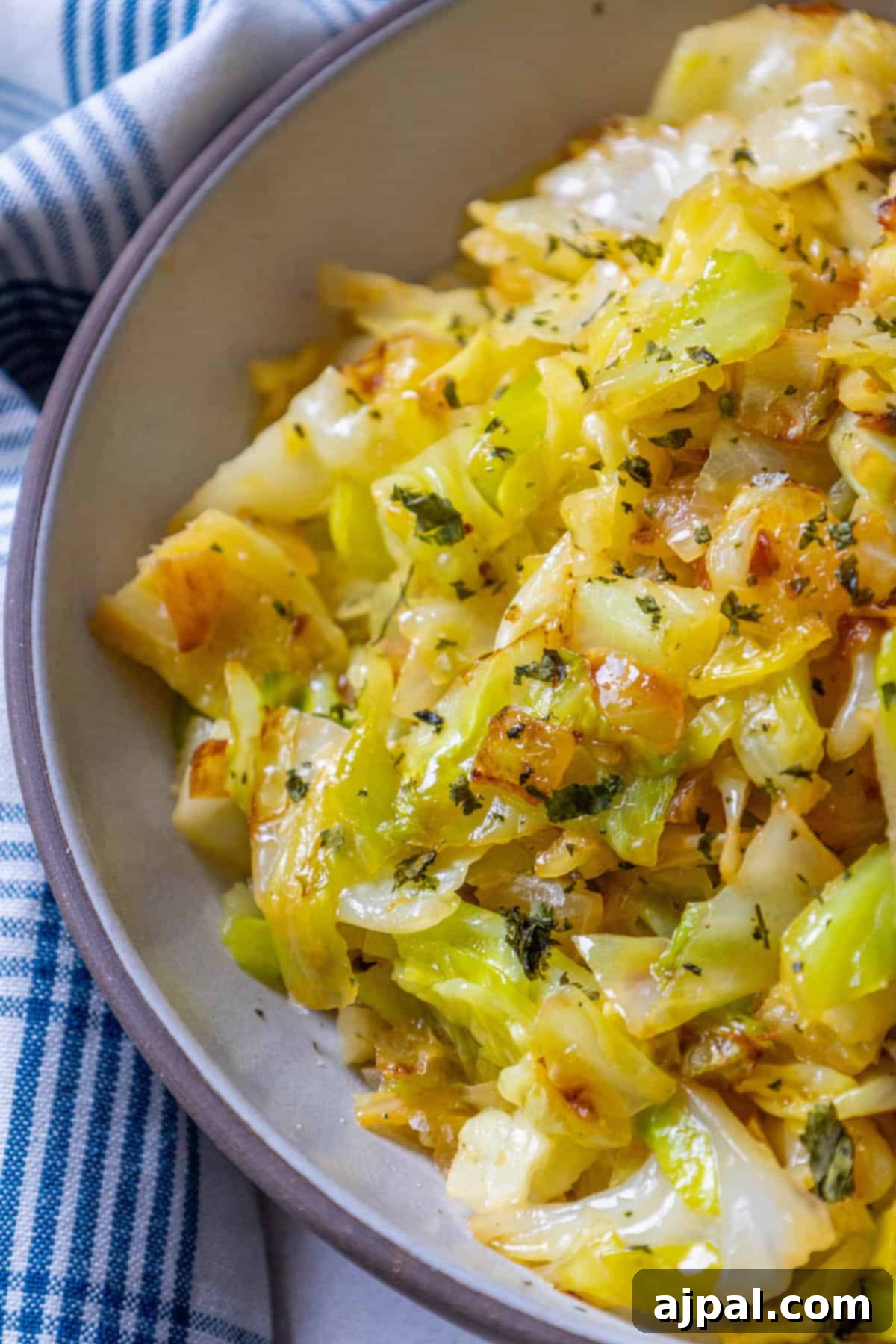 Caramelized Cabbage and Onions 11 A keto-friendly cabbage dish, beautifully presented in a bowl on a blue and white checkered cloth, ideal for St. Patrick's Day.