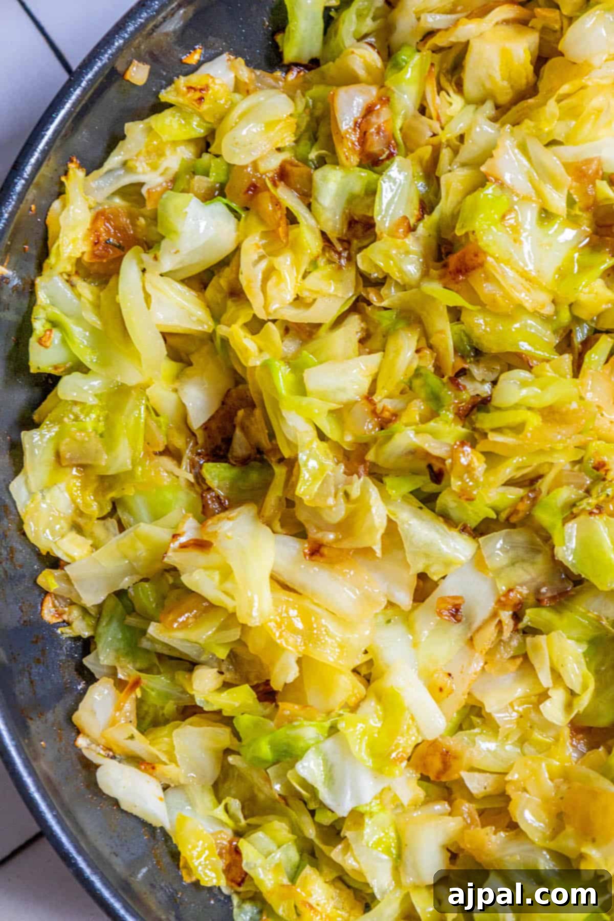 Caramelized Cabbage and Onions 9 A classic St. Patrick's Day cabbage recipe, featuring vibrant green sautéed cabbage with onions in a large skillet, ready to serve.