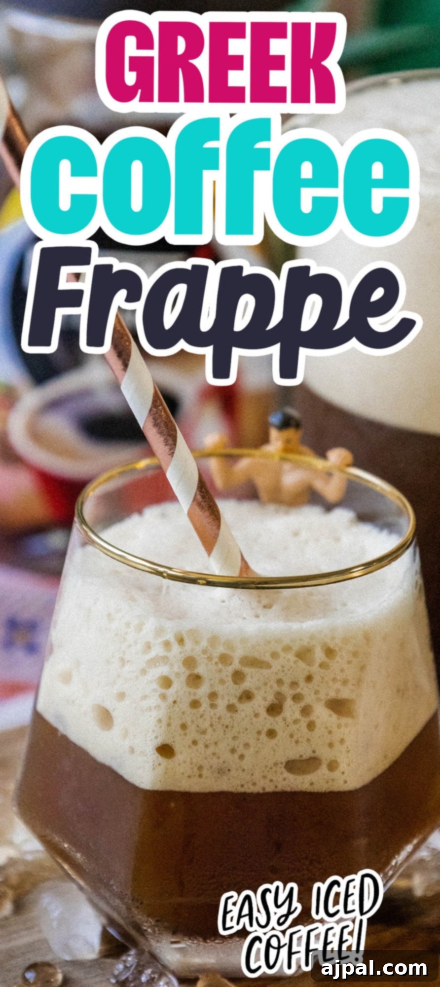 Whipped Greek frappé coffee in a glass with ice and foam and a paper straw on a table
