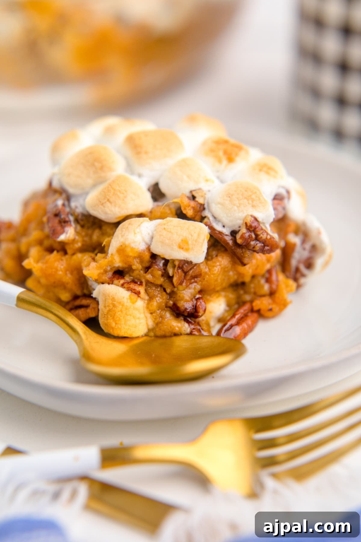 Golden Sweet Potato Delight 2 sweet potato with pecans and marshmallows on a plate