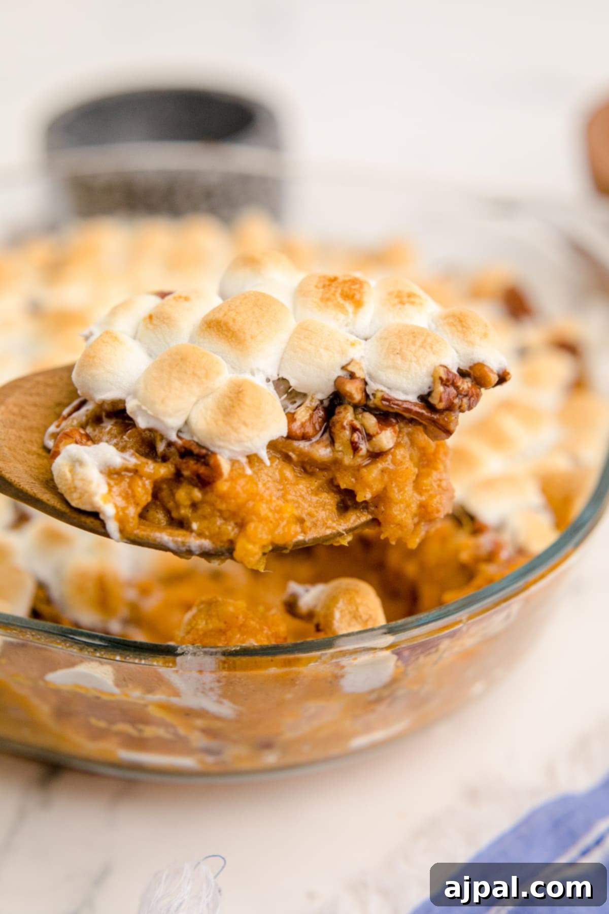 Golden Sweet Potato Delight 13 sweet potato with pecans and marshmallows on a spoon