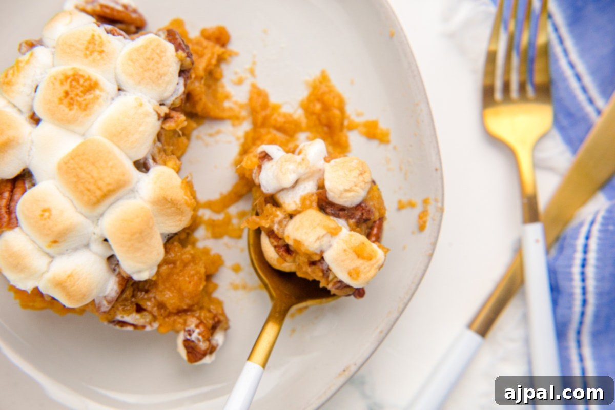 Golden Sweet Potato Delight 16 sweet potato with pecans and marshmallows on a spoon