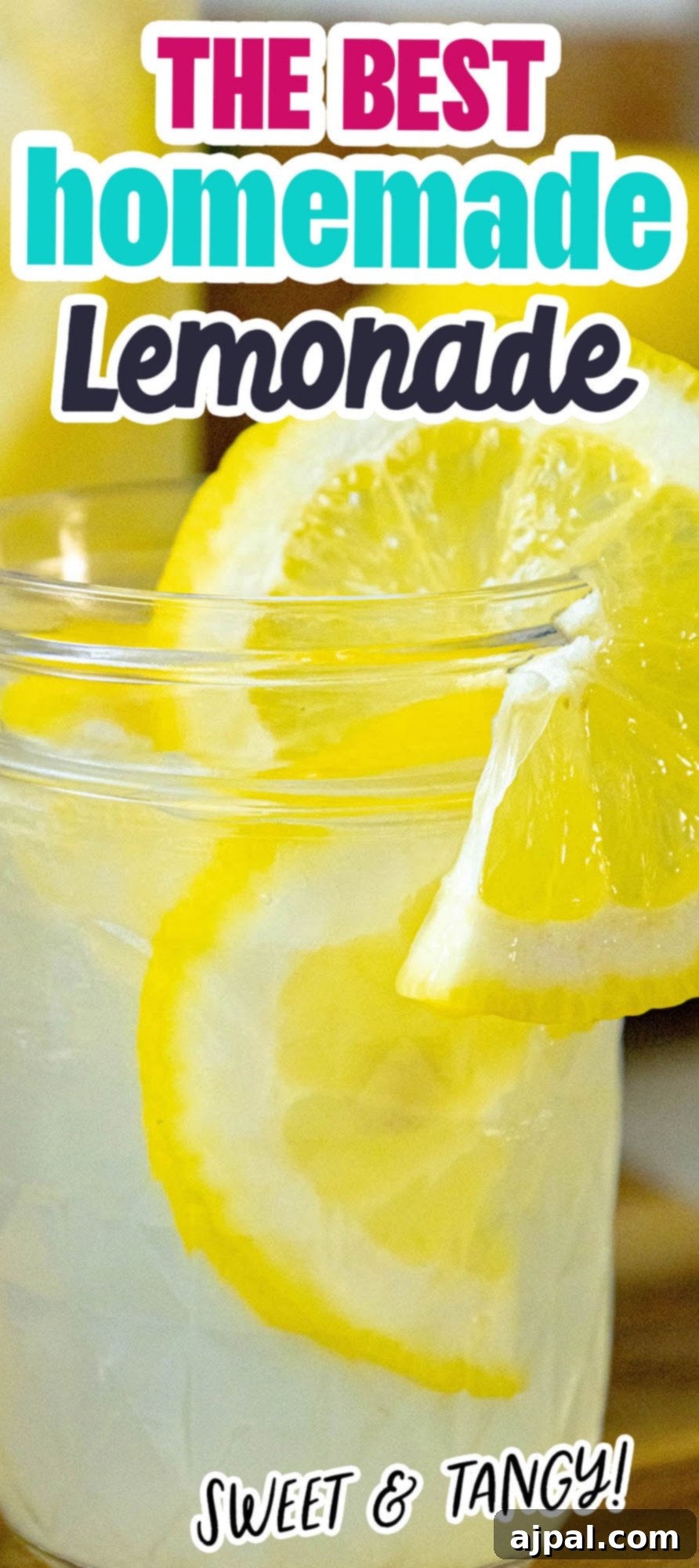 A vibrant glass jar filled with the best homemade lemonade, adorned with a fresh lemon slice and pebble ice, ready for a refreshing sip.