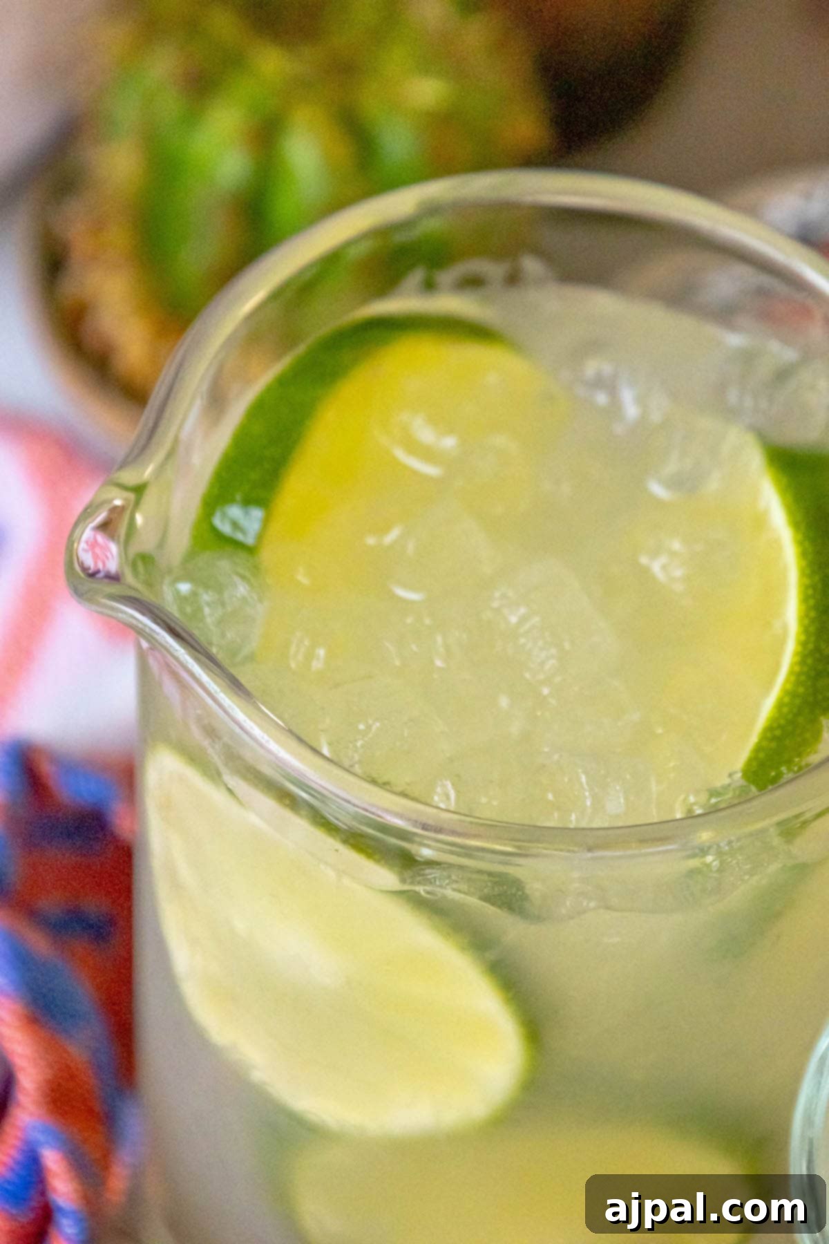 A pitcher of refreshing limeade with ice and sliced limes, ready for enjoyment.