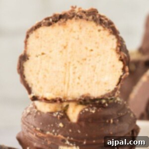 A S'mores truffle with a bite taken out, stacked on another truffle, showcasing its delicious interior.