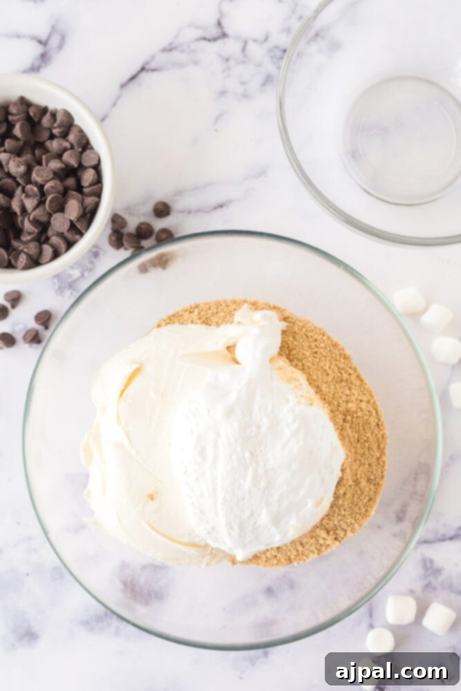 A bowl containing graham crackers and marshmallow fluff, ready for mixing to create S'mores truffles.