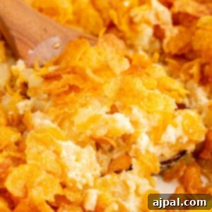 cheesy baked potatoes in a dish topped with cornflakes