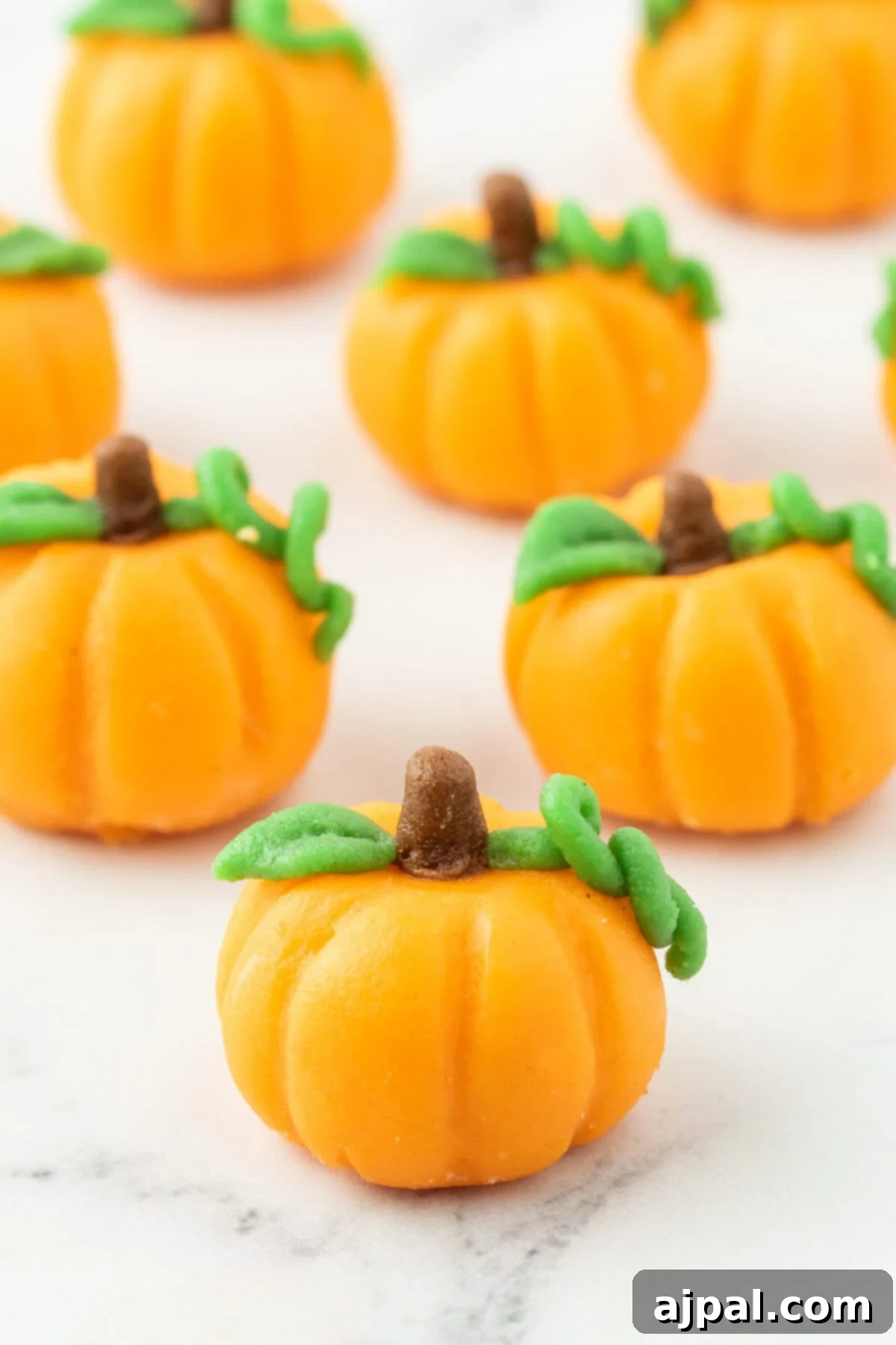 marzipan pumpkin with stem and leaf on a table