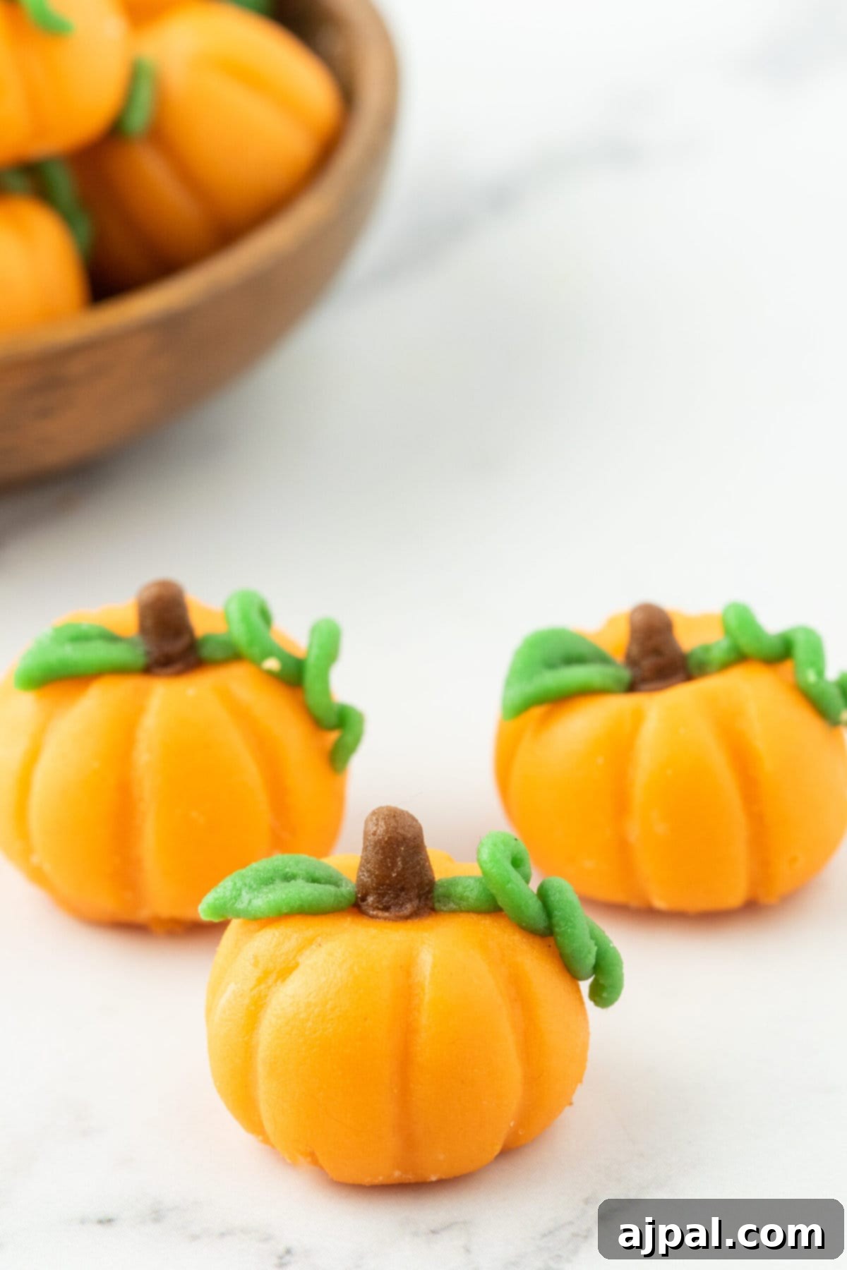 marzipan pumpkin with stem and leaf on a table