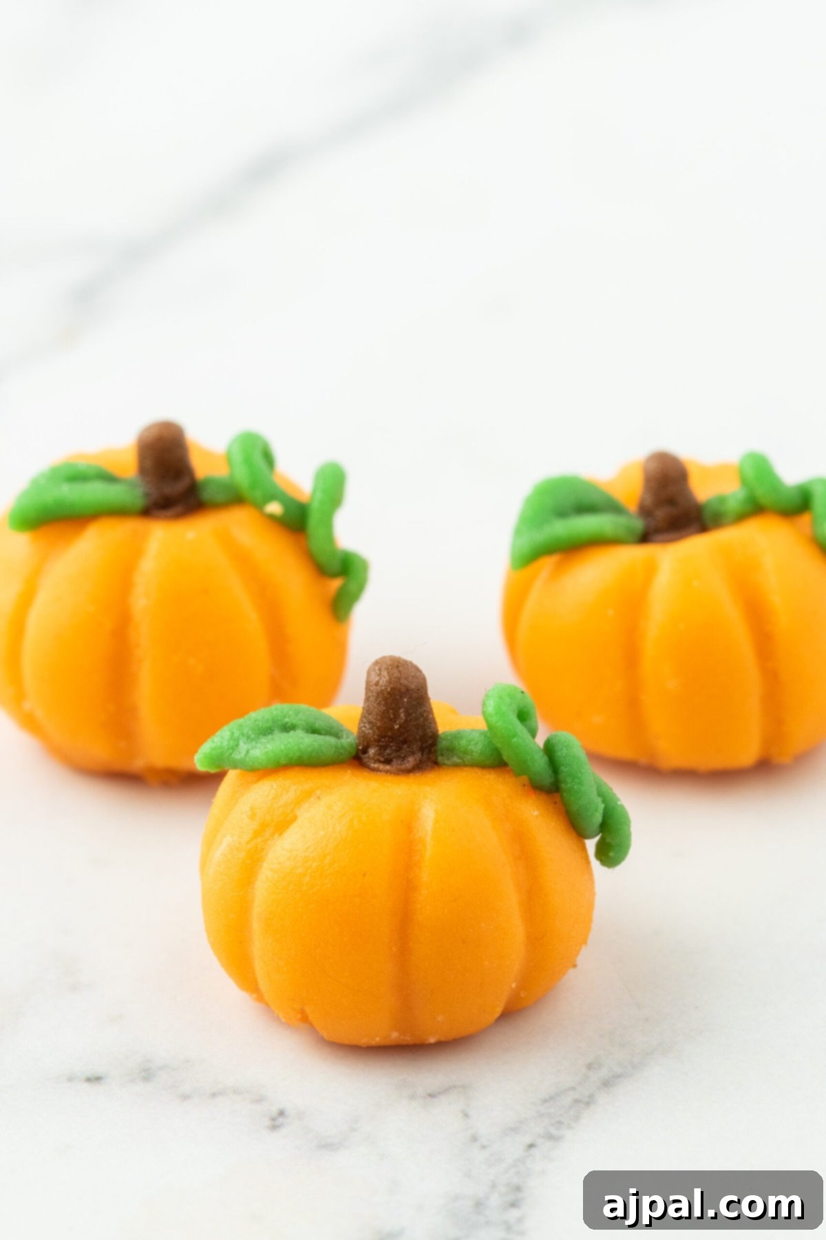 marzipan pumpkin with stem and leaf on a table