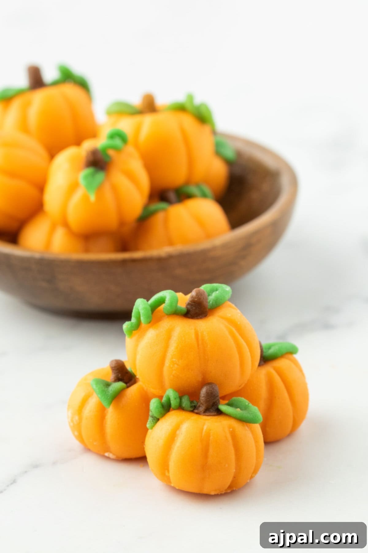 marzipan pumpkin with stem and leaf on a table