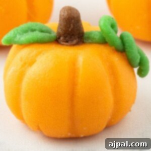 marzipan pumpkin with stem and leaf on a table