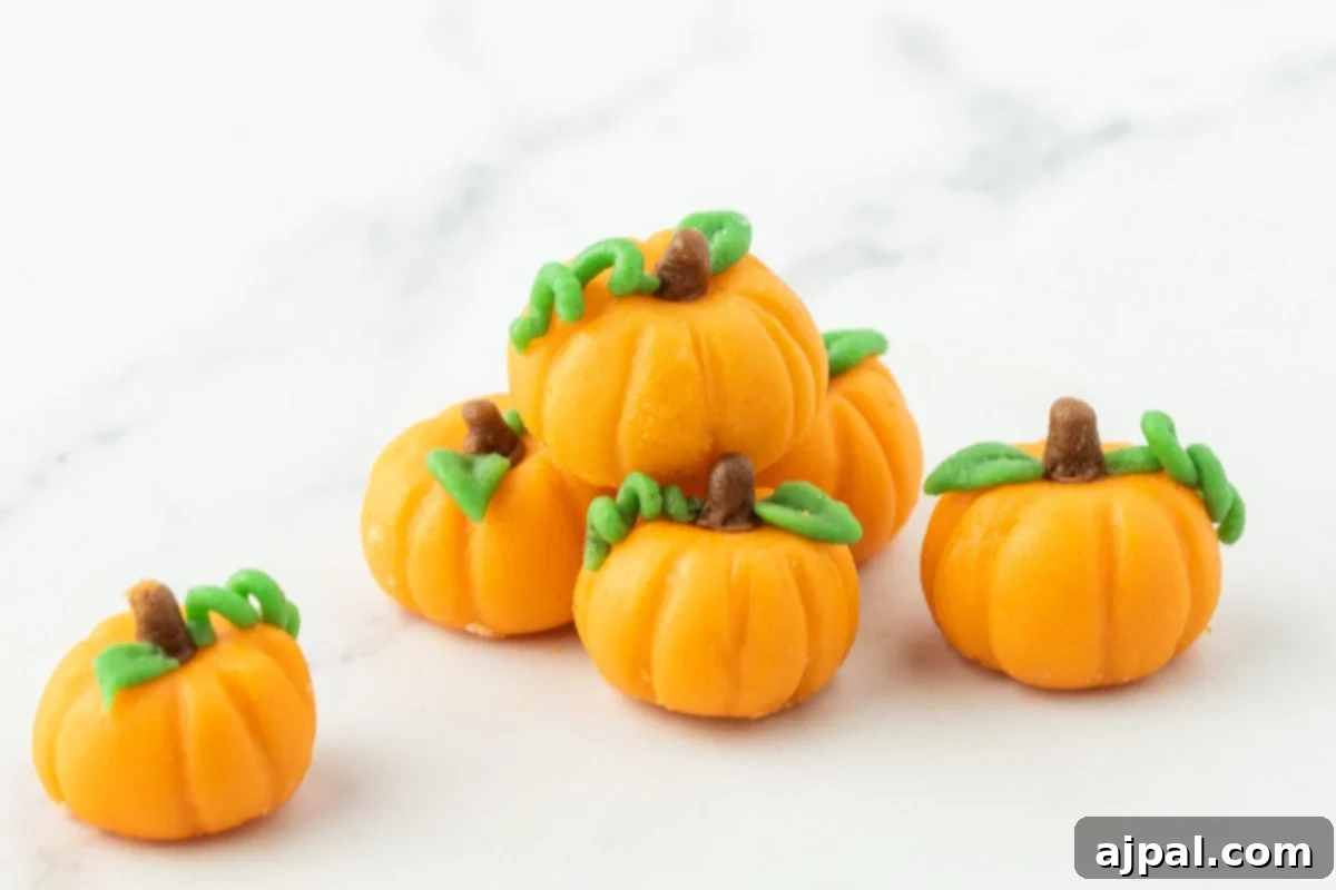marzipan pumpkins with stem and leaf on a table
