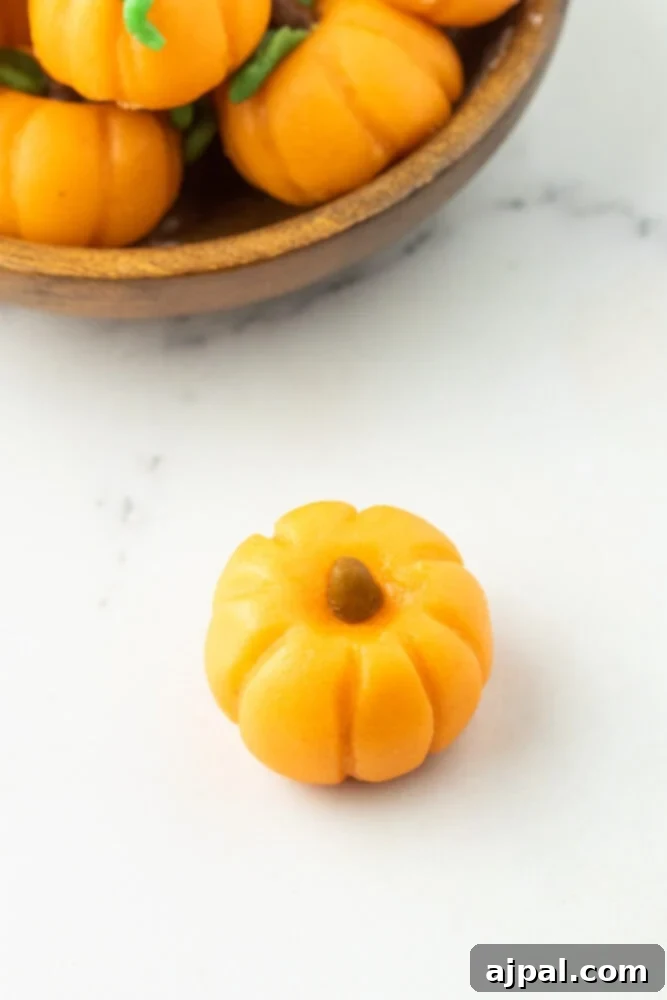 marzipan shaped into a pumpkin with a stem