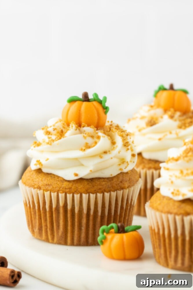 Golden Pumpkin Spice Cupcakes 3 The best pumpkin cupcakes topped with whipped cream and a sprinkle of cinnamon.