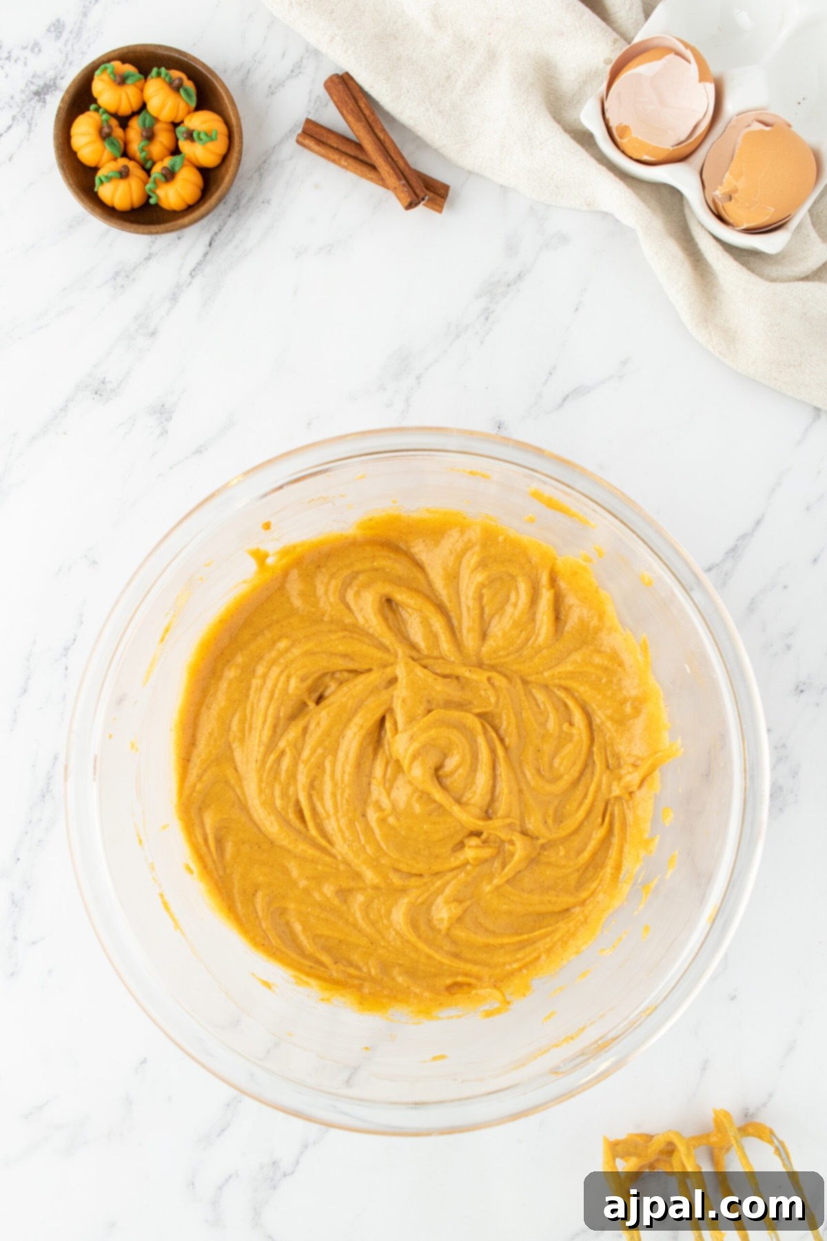 Golden Pumpkin Spice Cupcakes 7 Mixed pumpkin cupcake batter in a bowl, smooth and ready to be scooped.