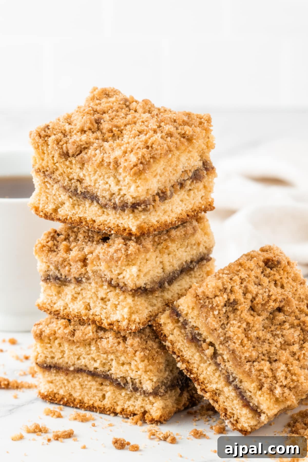 Coffee cake slices stacked on a table with a rustic backdrop