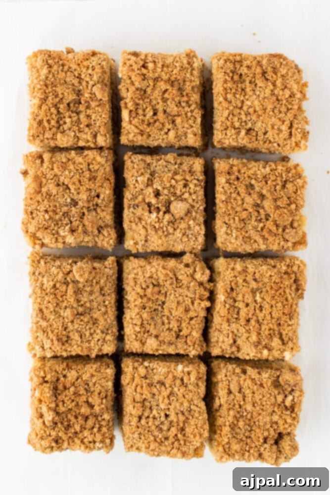 A tempting slice of homemade coffee cake, showcasing its moist interior and crumbly topping, presented on a plate.