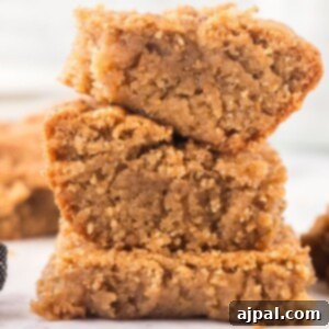Snickerdoodle blondies stacked on a table, showcasing their golden-brown top