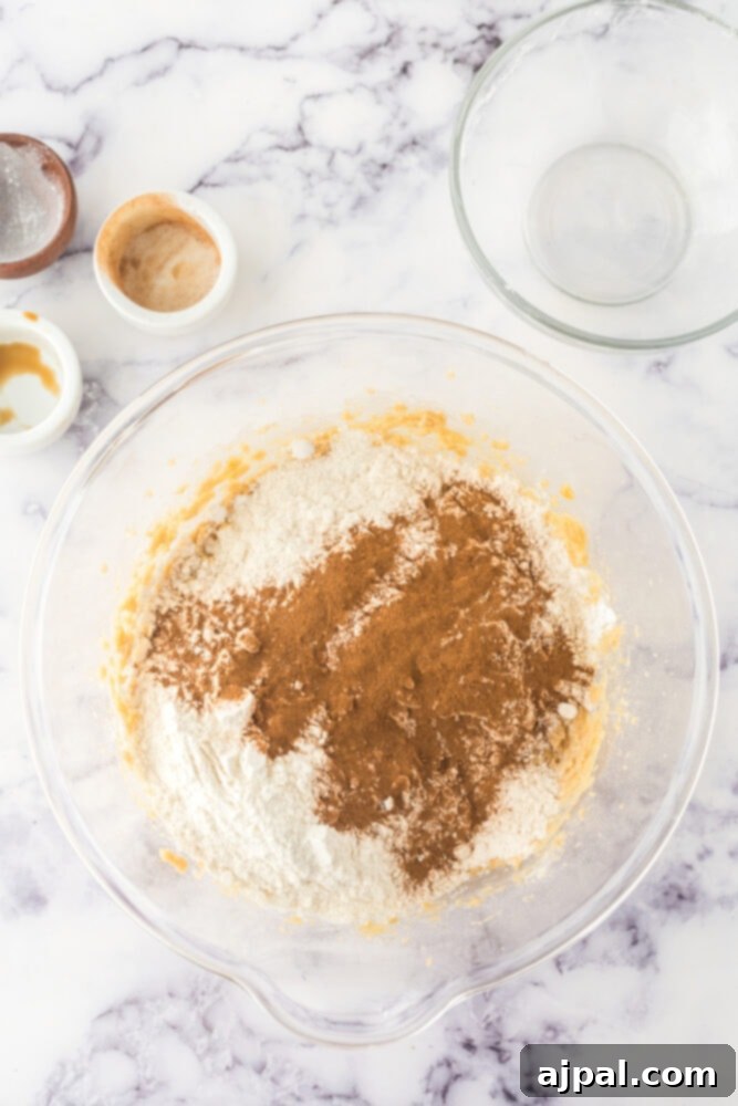 Dry ingredients for Snickerdoodle Blondies in a bowl, including flour, baking powder, and cinnamon