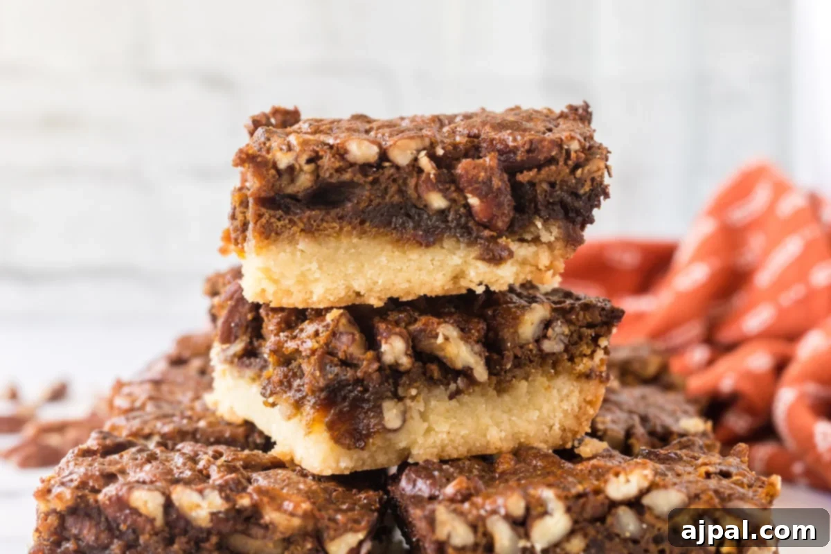 Pecan Pie Bars 12 A stack of pecan pie bars, featuring a golden brown crust and a rich pecan topping.