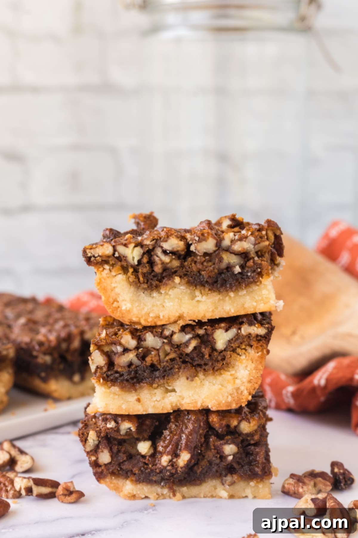 Pecan Pie Bars 14 A beautiful stack of easy pecan pie bars, highlighting their inviting texture and golden hue.