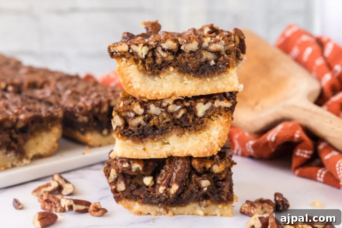 Pecan Pie Bars 3 Two pecan pie bars, one stacked atop the other, displaying the rich pecan topping.