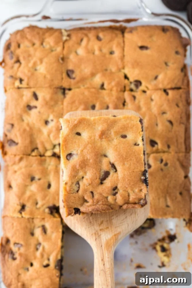 Decadent Oreo Bars 5 Easy chocolate chip cookie bars stuffed with Oreos, served with a wooden spatula.