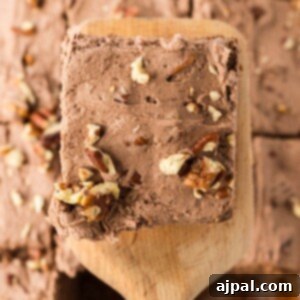 a slice of chocolate pecan sheet cake on a spatula