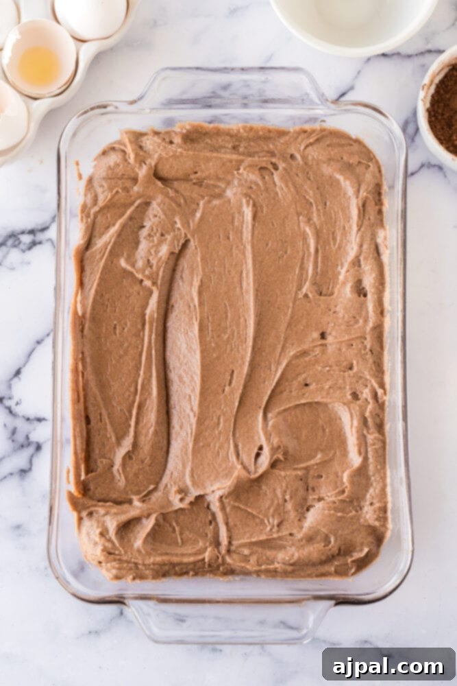iced chocolate cake in a glass casserole dish