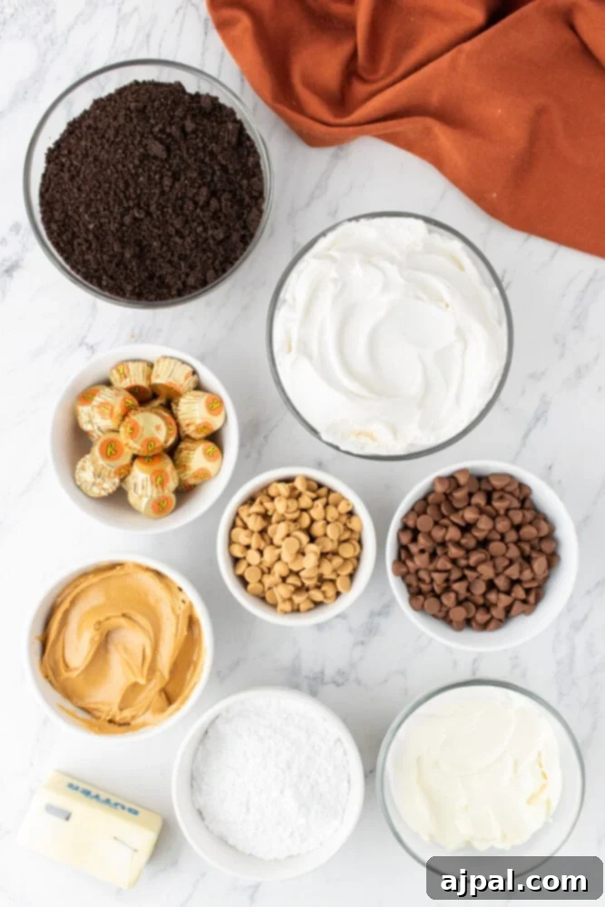 Assortment of key ingredients for Reese's Peanut Butter Pie including peanut butter, chocolate crumbs, powdered sugar, cream cheese, butter, mini peanut butter cups, and peanut butter chips.