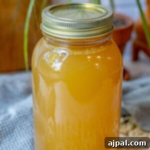Homemade Slow Cooker Turkey Stock 11 Honey and slow cooker on a table.