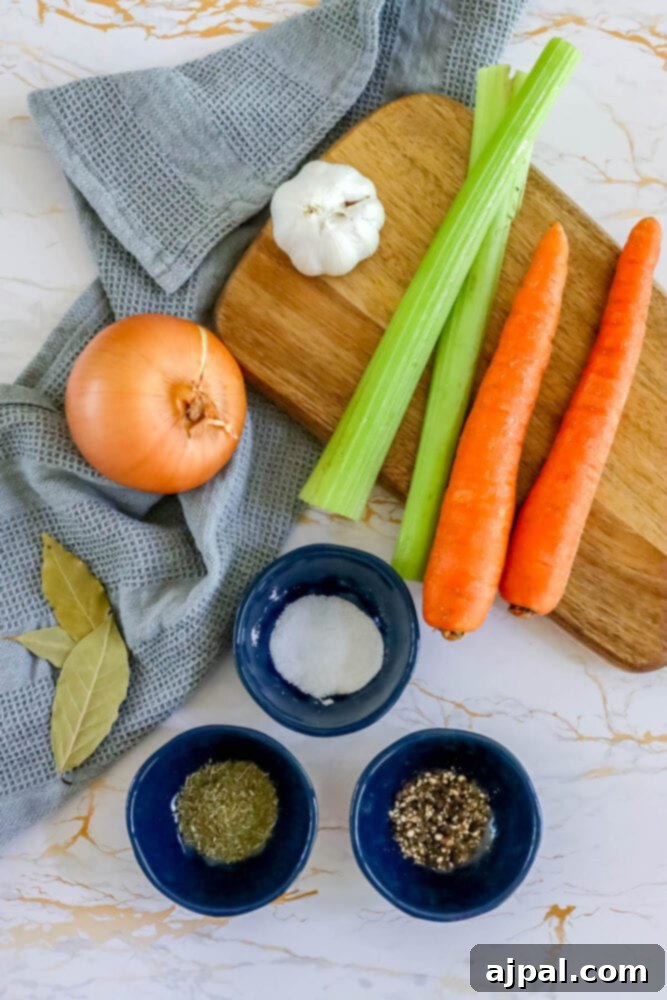Homemade Slow Cooker Turkey Stock 5 Carrots, onion, garlic, bay leaves, and spices artfully arranged on a cutting board, ready for making slow cooker turkey stock.