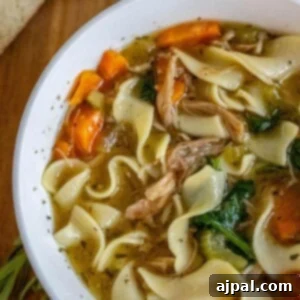 Hearty Slow Cooker Turkey Noodle Soup 13 Slow cooker chicken noodle soup in a white bowl.