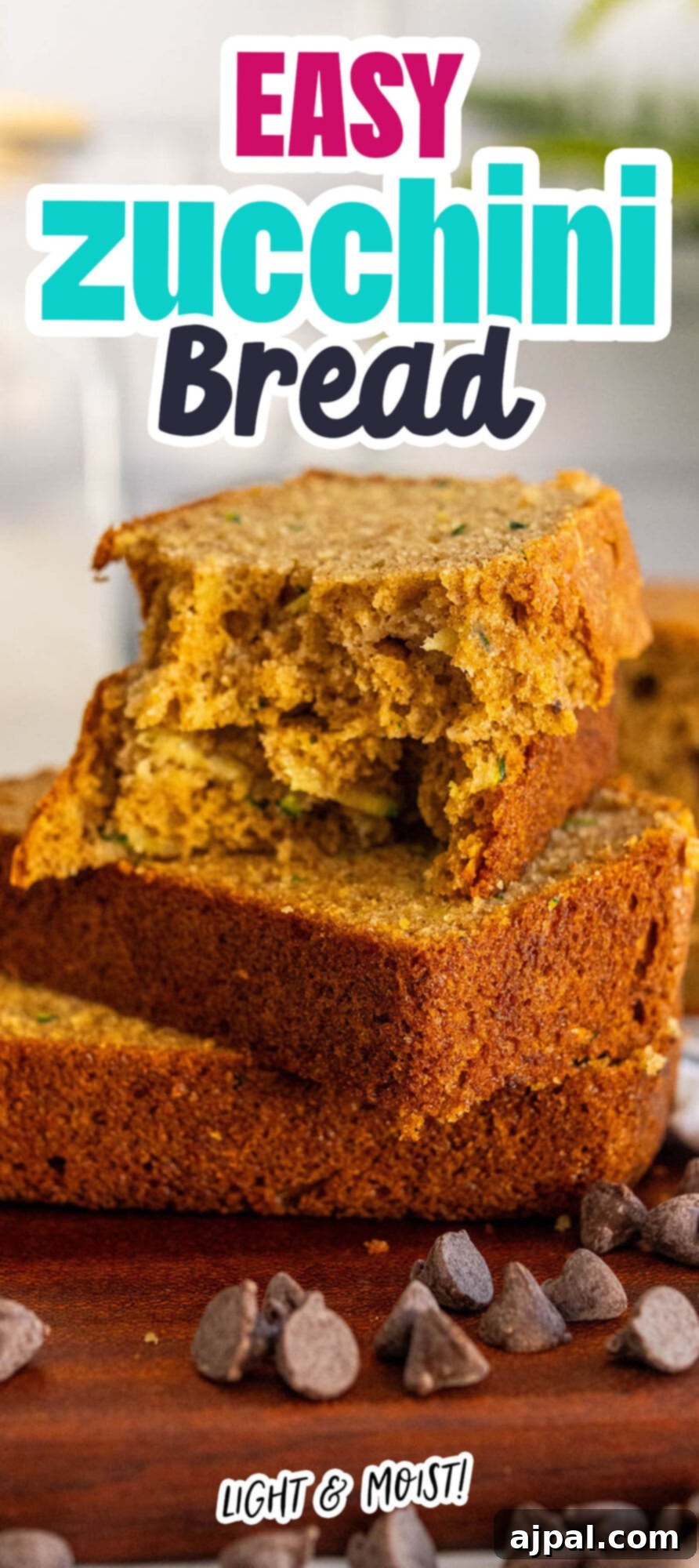 baked zucchini bread slices stacked on top of each other on a cutting board