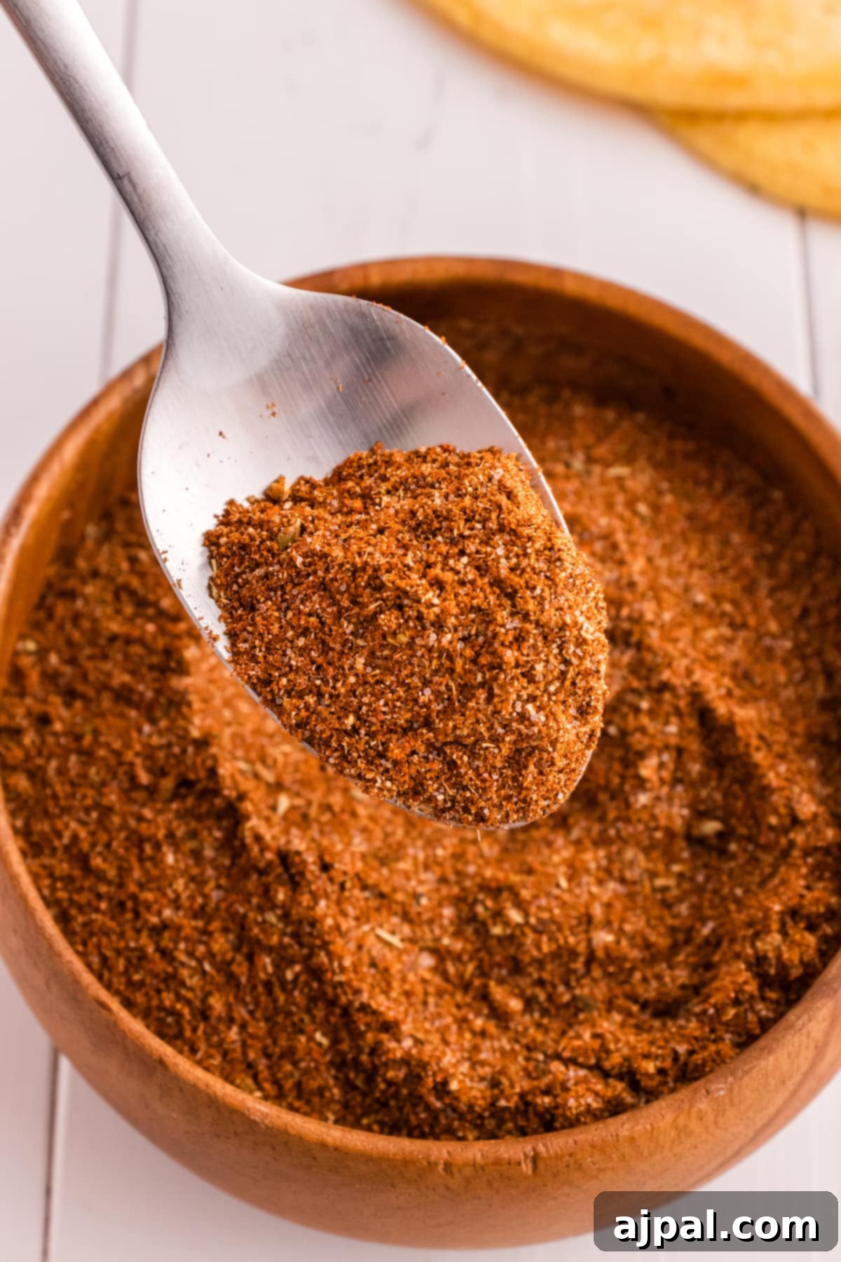 Flavorful Taco Blend 2 A spoonful of taco mix in a wooden bowl.