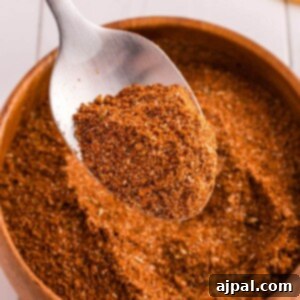 Homemade taco seasoning on a wooden spoon, ready to be used in a delicious meal.