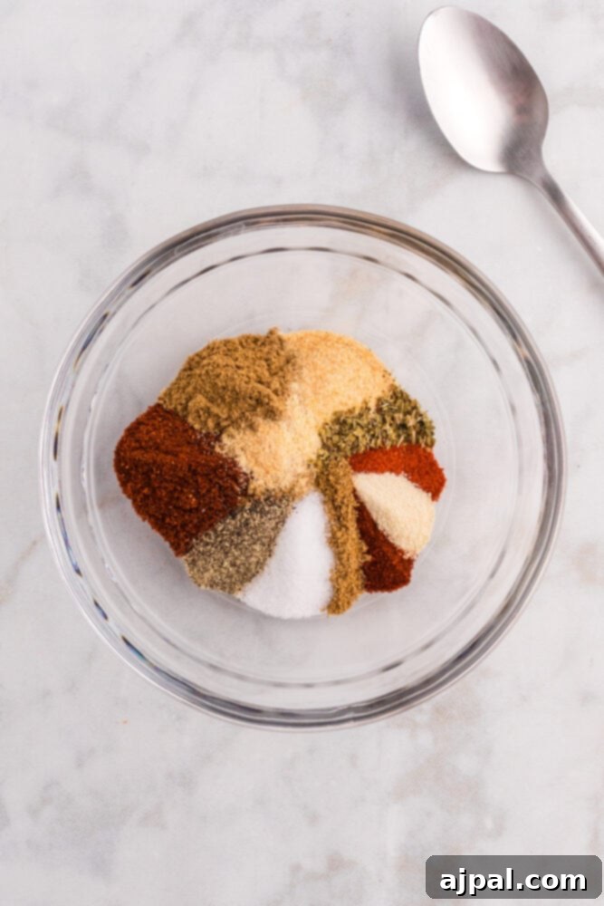 Taco Spice Blend 6 A close-up of mixed taco seasoning herbs and spices in a white bowl, ready for blending.