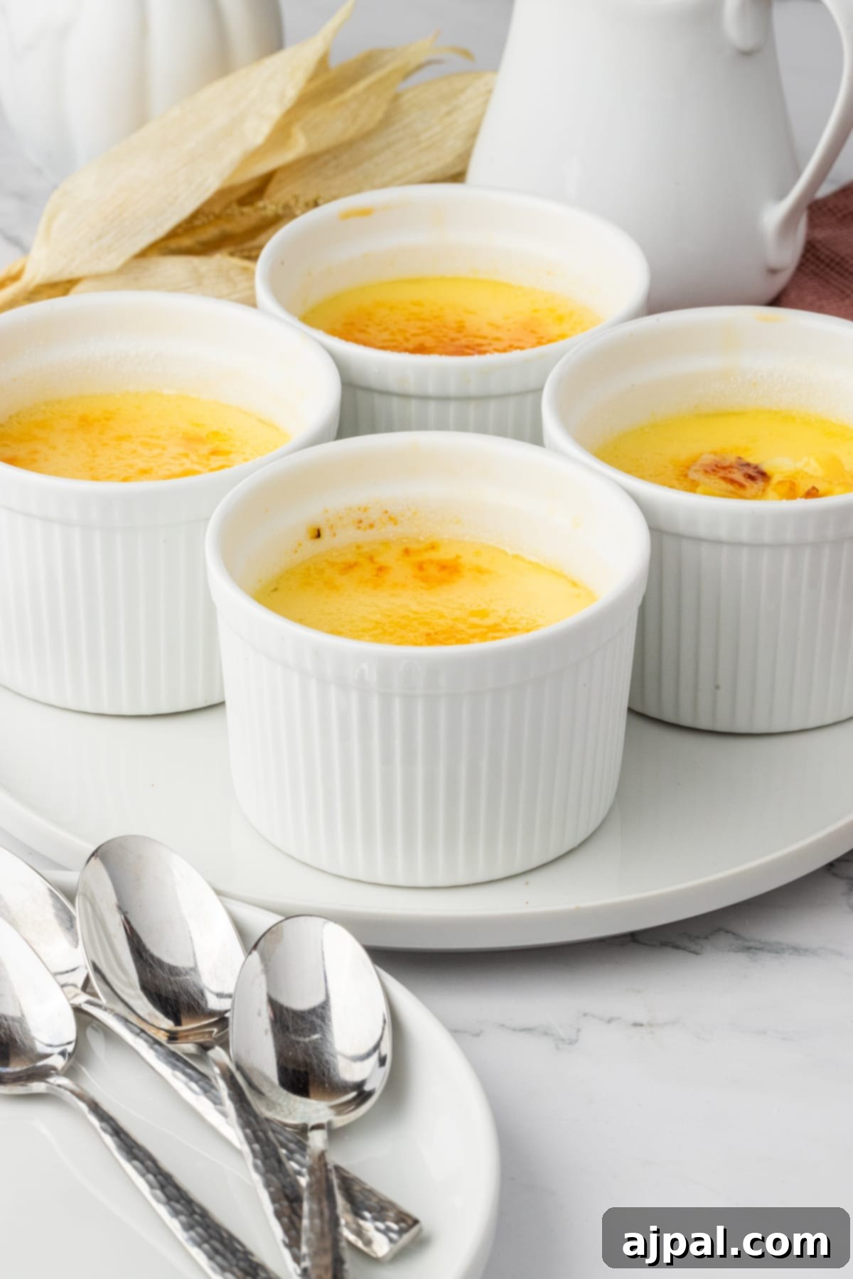 Your Instant Pot's Secret to Perfect Creme Brulee 14 Creme Brûlée in small white ramekins on a white plate