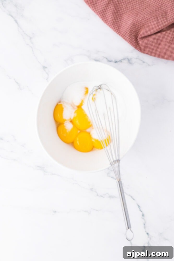 Your Instant Pot's Secret to Perfect Creme Brulee 6 egg yolks, sugar, and a whisk in a bowl